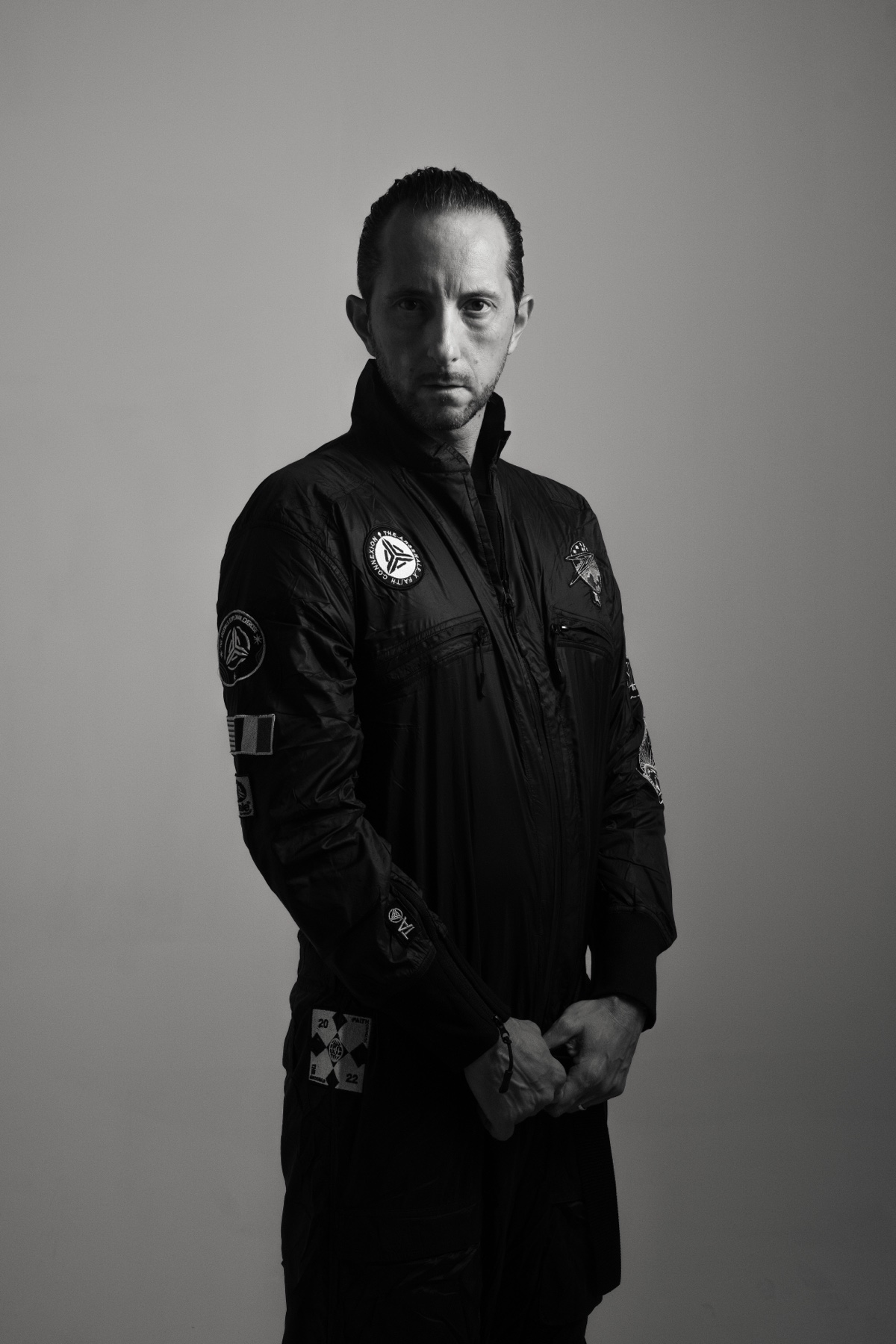 Black-and-white portrait of Patrice Meignan wearing a TheArsenale flight suit.